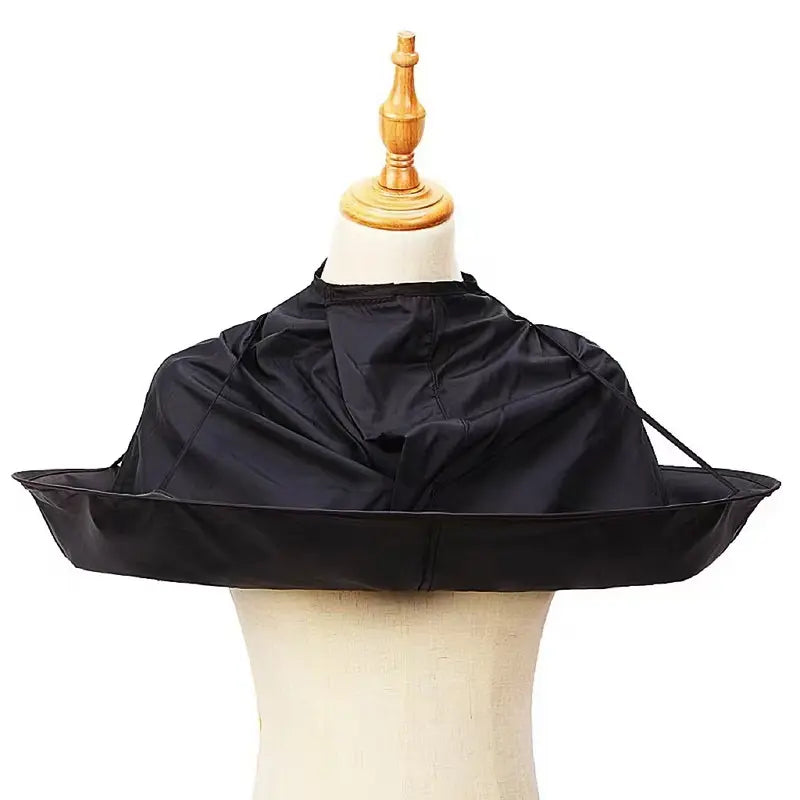 Lightweight water-resistant hair cutting cape worn during a haircut